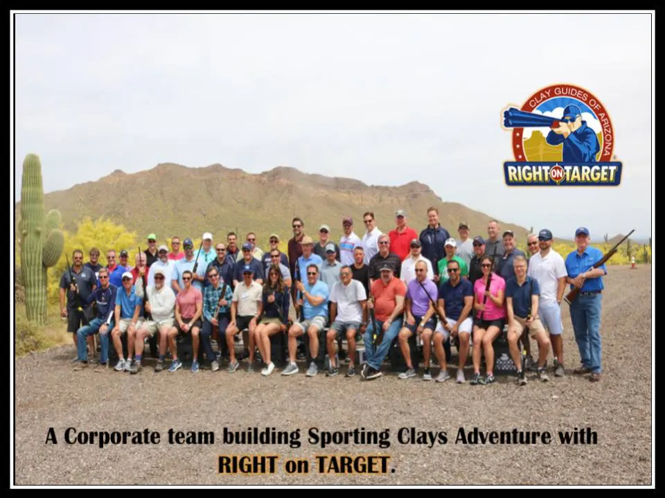 A group of people standing in front of a mountain.