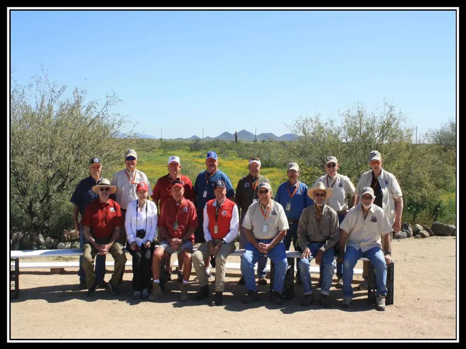 A group of men sitting on top of a bench.