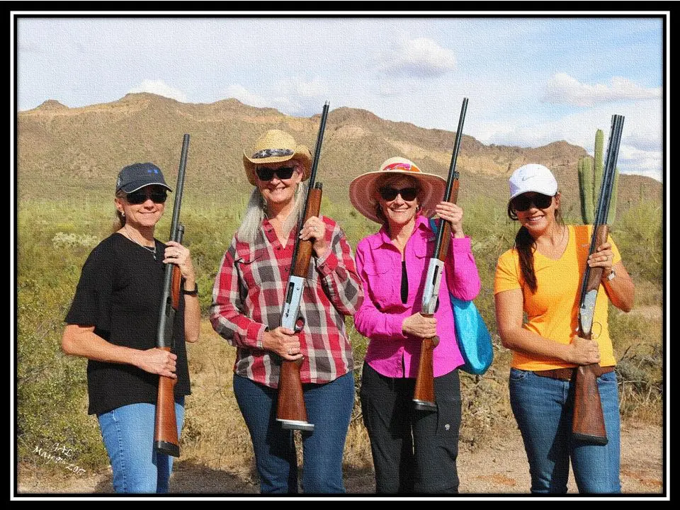 A group of women holding guns in their hands.