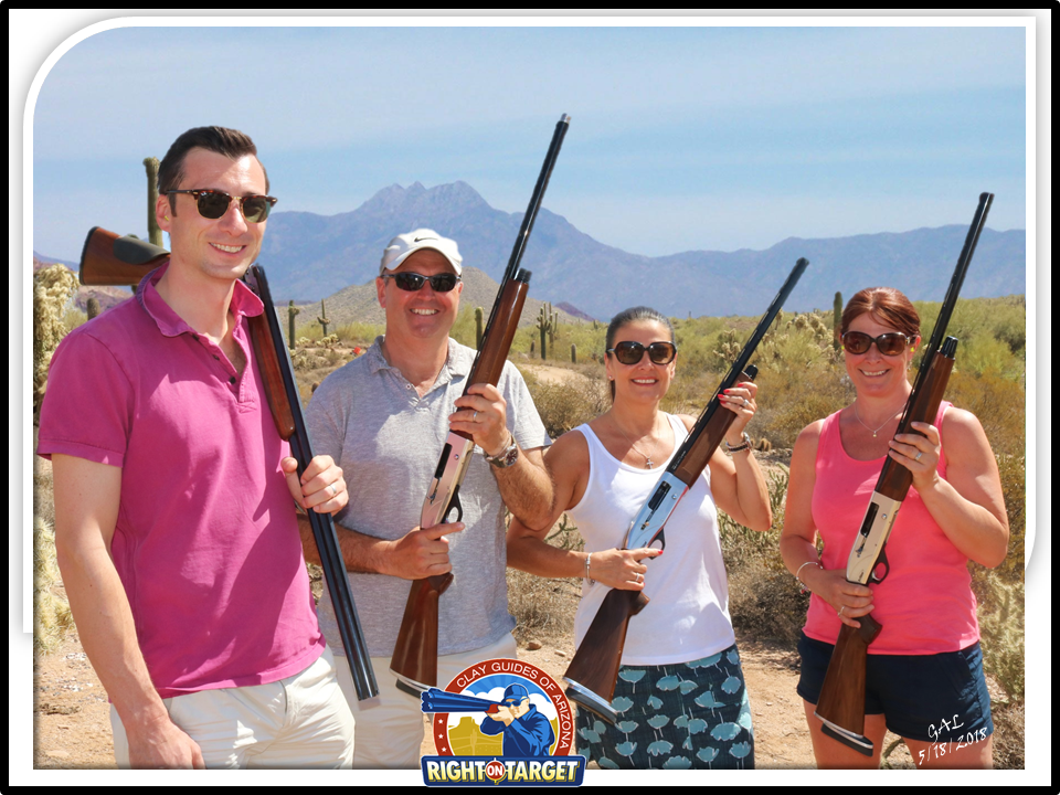 A group of people holding guns in the desert.
